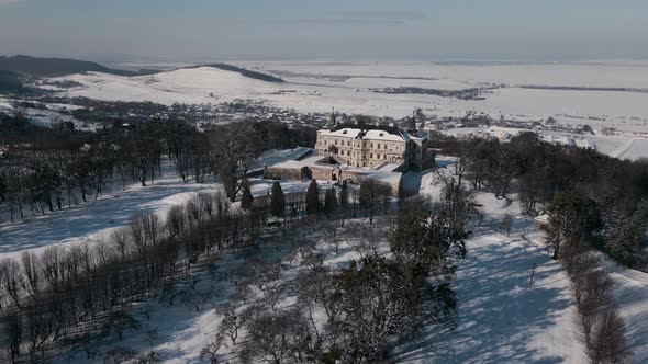 Aerial View Drone Flight Forward Over the Historic Old Castle at Sunny Winter Day Pidhirtsi Palace