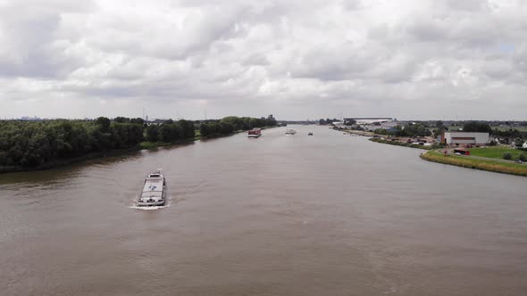 Aerial View Of Inland Freighter Turning On River Noord At Ridderker. Dolly Back