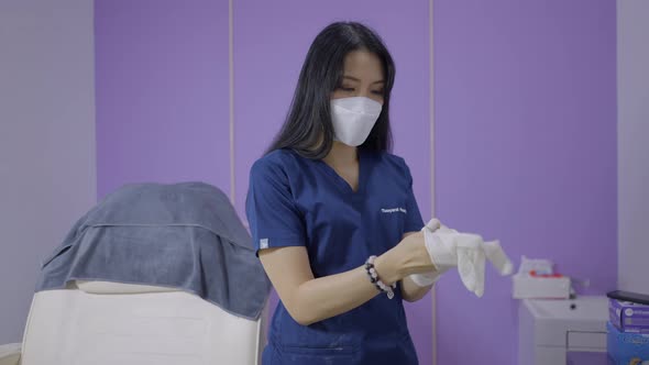 Aesthetic Doctor Puts on White Gloves and Picks Up Needle at Her Beauty Salon in Bangkok