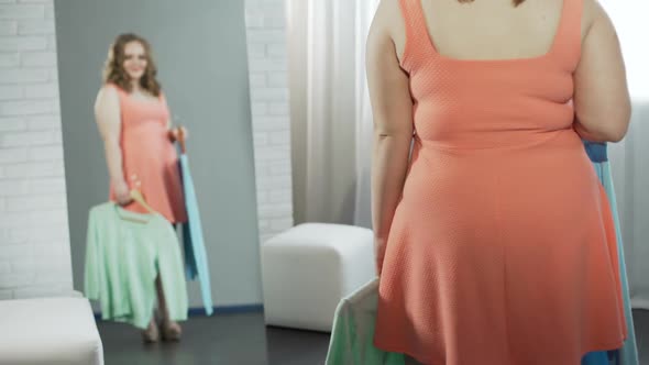 Oversize Girl Choosing Blouse in Dressing Room at Boutique, Plus Size Fashion