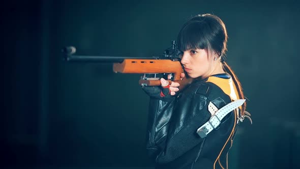 Girl Shooting From a Rifle