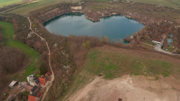 Forwards Tilt Up Reveal of Water Surface in Shape of Heart and Rural Landscape Next By Lake