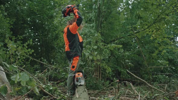 Portrait of a Woman Logger Standing in the Forest Female Specialist in Protective Gear Puts Off