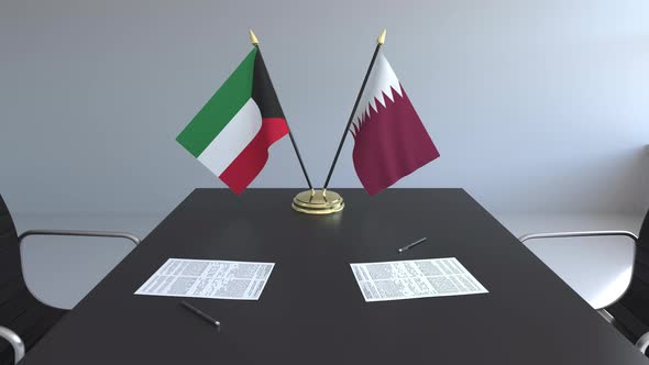 Flags of Kuwait and Qatar on the Table