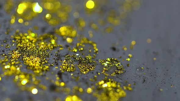 Macro Close Up Shot Of Golden Wet Glitter. Golden Space Glittering Particle Background. 