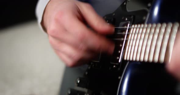 Closeup Creative Musician Playing Fingerpicking with on a Blue Electric Guitar