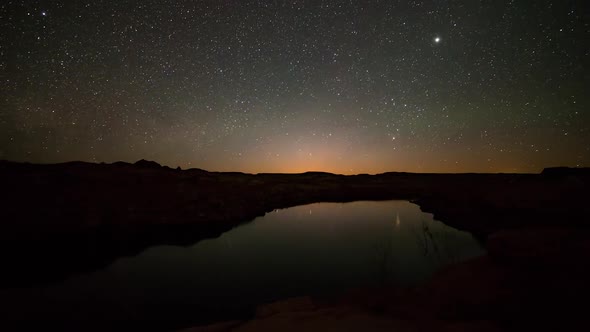 Time lapse of the moon rising over lake in the desert