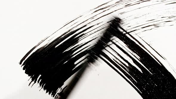 Macro Shot and Slow Motion of a Black Mascara Isolated on White Background