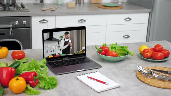 Laptop Computer with Man Food Blogger Shows Slice Cucumber Tells Teaches Student