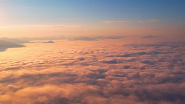 4K Drone Flying through the clouds at dusk or dawn. Aerial top cloudscape