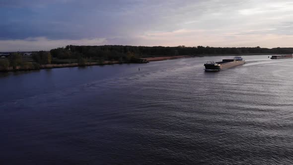 Freighter Of Excelsior Shipping Navigates The River In Barendrecht  At Daytime. wide shot