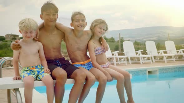 Four Kids Swaying and Having Fun By the Pool Side