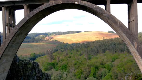 Aerial Drone Flying Back Through Gundián Viaduct spanning Ulla River In Galicia With Visitors Crossi