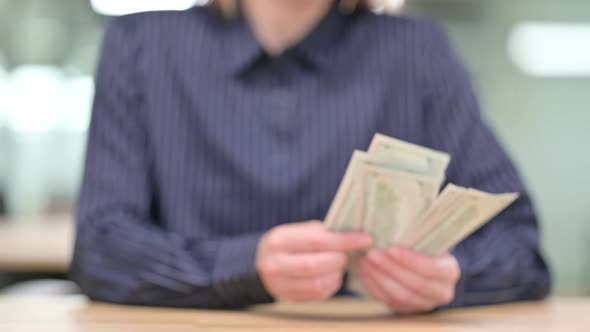 Close Up of Businesswoman Counting Dollar and Giving