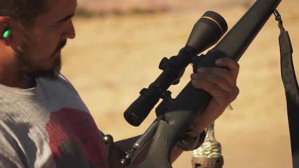 Close Up Of Inspecting Rifle And Loading The Weapon In Summer.