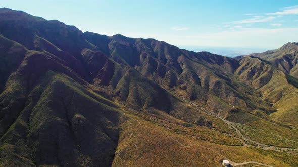 Aerial Drone Shot Of Beautiful Summer Desert Mountain Range Covered In Green Foliage Near Famous US