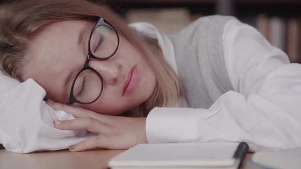 Schoolgirl with Glasses Learns Lessons Cute Girl Sleeping in Library While Doing Homework