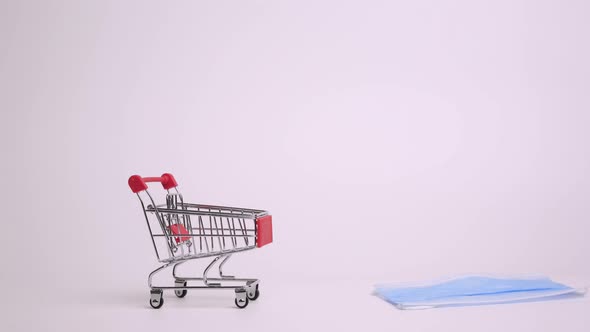 Shopping Cart Trolley with Protective Medical Mask Against Coronavirus. Stop Motion Animation. Safe