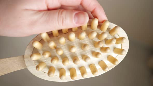 Closeup of a Woman's Hand Holding a Lymphatic Drainage Brush