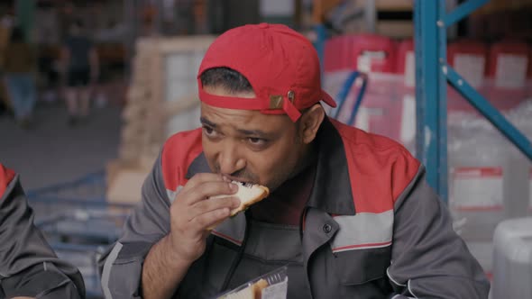 Middle-Eastern Warehouse Workman Having Lunch