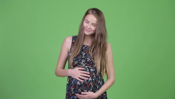 Young Happy Pregnant Woman Thinking While Looking Up