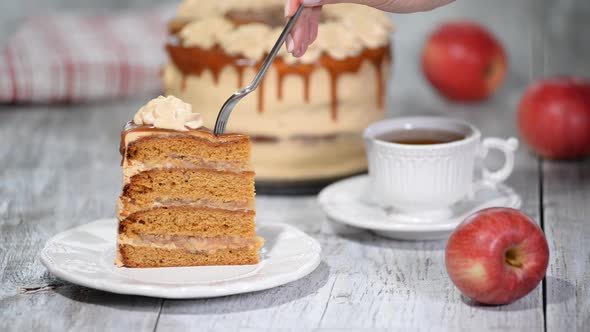 Piece of Caramel Apple Cake with spices, cinnamon, creamy caramel in autumn style