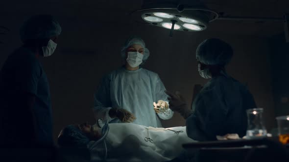 Medical Team Performing Surgery in Hospital Room