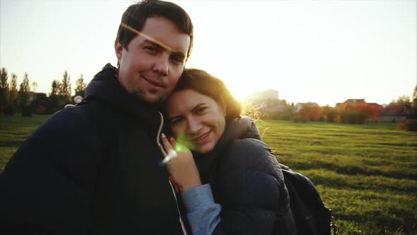 Young Man and Woman Making Selfie Outdoor Strong Back Light Slow Motion