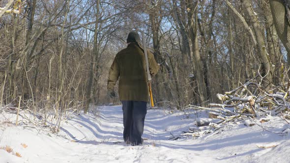 Hunter Walking in the Snowy Winter Forest. Winter Hobby, Sun, Hunting Concept