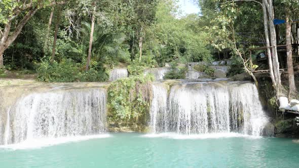 Water flowing from Cambugahay Falls into natural turquoise pool in Siquijor Island, the Philippines