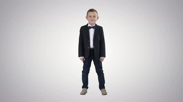 Smiling Little Boy in Formal Clothes Standing on Gradient Background.