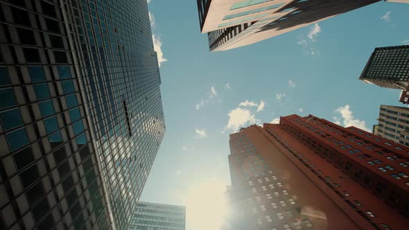 Bottom View of Pass By Several Skyscrapers in a Peaceful City Under the Cloudy Sky in Calm Day