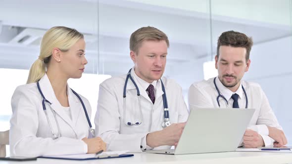 Professional Team of Doctors Doing Video Chat on Laptop