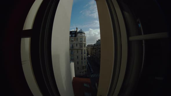 Timelapse of traffic in Parisian street, clouds sailing in the sky