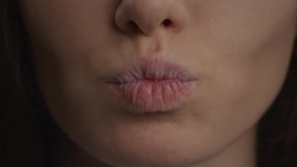 Close Up of a Caucasian Woman Lips Doing a Kiss and a Smile in Slow Motion