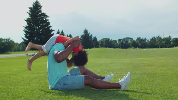 African Dad and Little Son Having Fun Outdoors