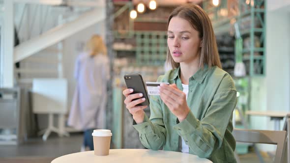 Shopping Online Via Smartphone in Cafe 