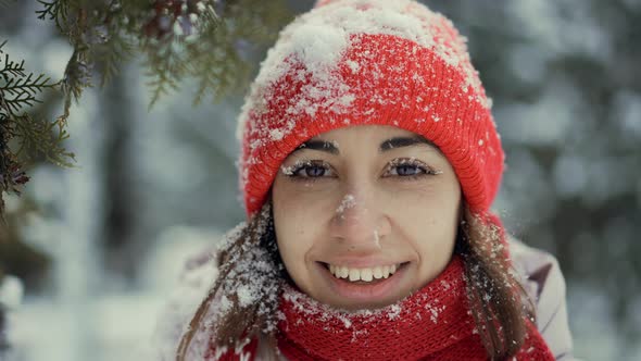 Slow Motion Extreme Close Up Face of Beautiful Smiling Woman in Knitted Red Beanie and Scarf