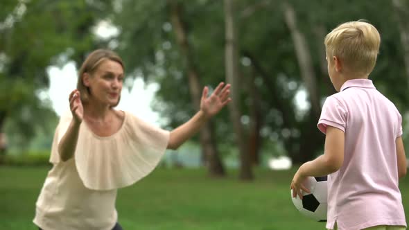 Boy Playing Soccer With Mom in Park, Happy Family Weekend, Healthy Lifestyle