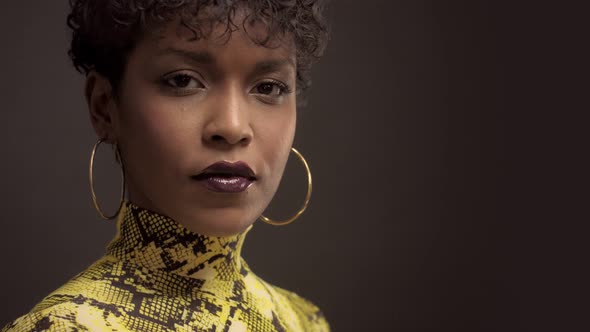 Mixed Race African American Woman in Bright Yellow Dress with Python Print