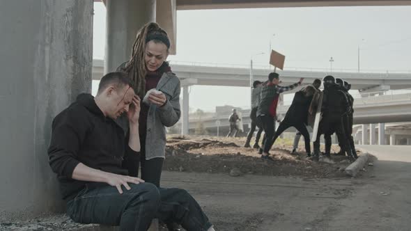 Woman Helping Wounded Man at Protest