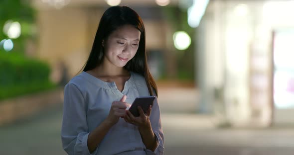 Woman use of smart phone in city