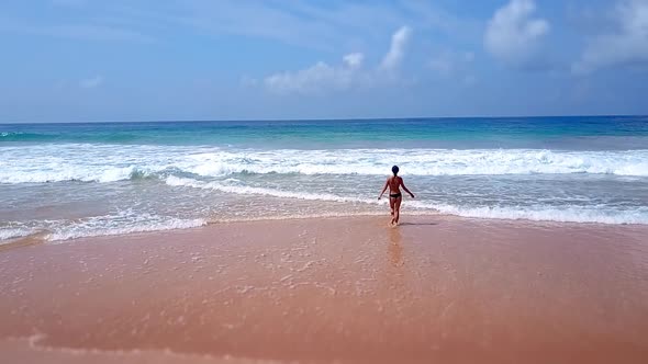 Asian Woman Feet Walking Barefoot Beach at Endless Ocean Seaside Leaving Footprints in Sand