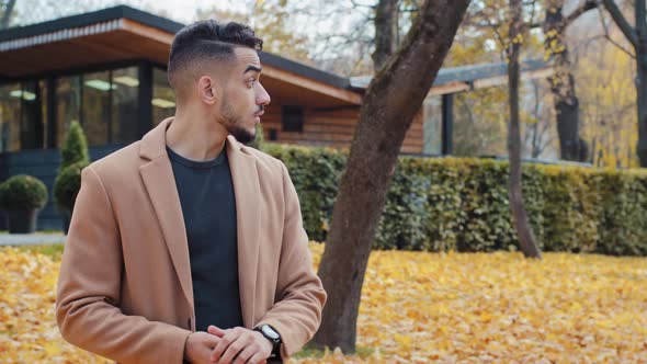 Arabic Man Waiting Woman Looks at Watch in Autumn Park Happy Meeting Old Friends Close Relationships