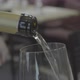 Closeup and Front View with Copy Space of Serving White Wine Being Poured From a Bottle Into Clear - VideoHive Item for Sale