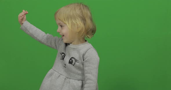 Kid Girl on a Green Screen, Chroma Key. Happy Three Years Old Girl