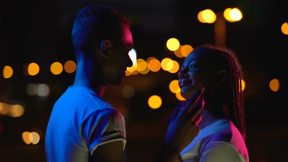 Teenage Boy and Girl Sensually Touching Hands, Romantic Date in Night Lights