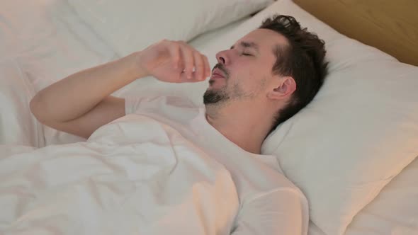 Sick Young Man Having Coughing in Bed