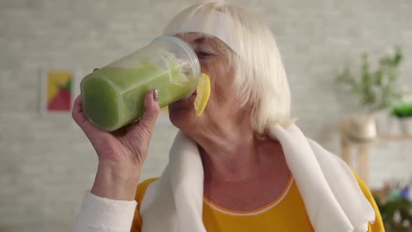 Positive Fitness Granny Drinks Green Smoothie in a Blender,sports Diet