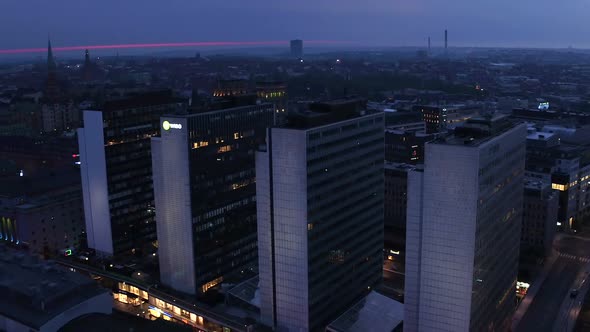 A aerial panoramic shot over Hötorget in central Stockholm Sweden at dusk. Focusing on Hötorget's sk